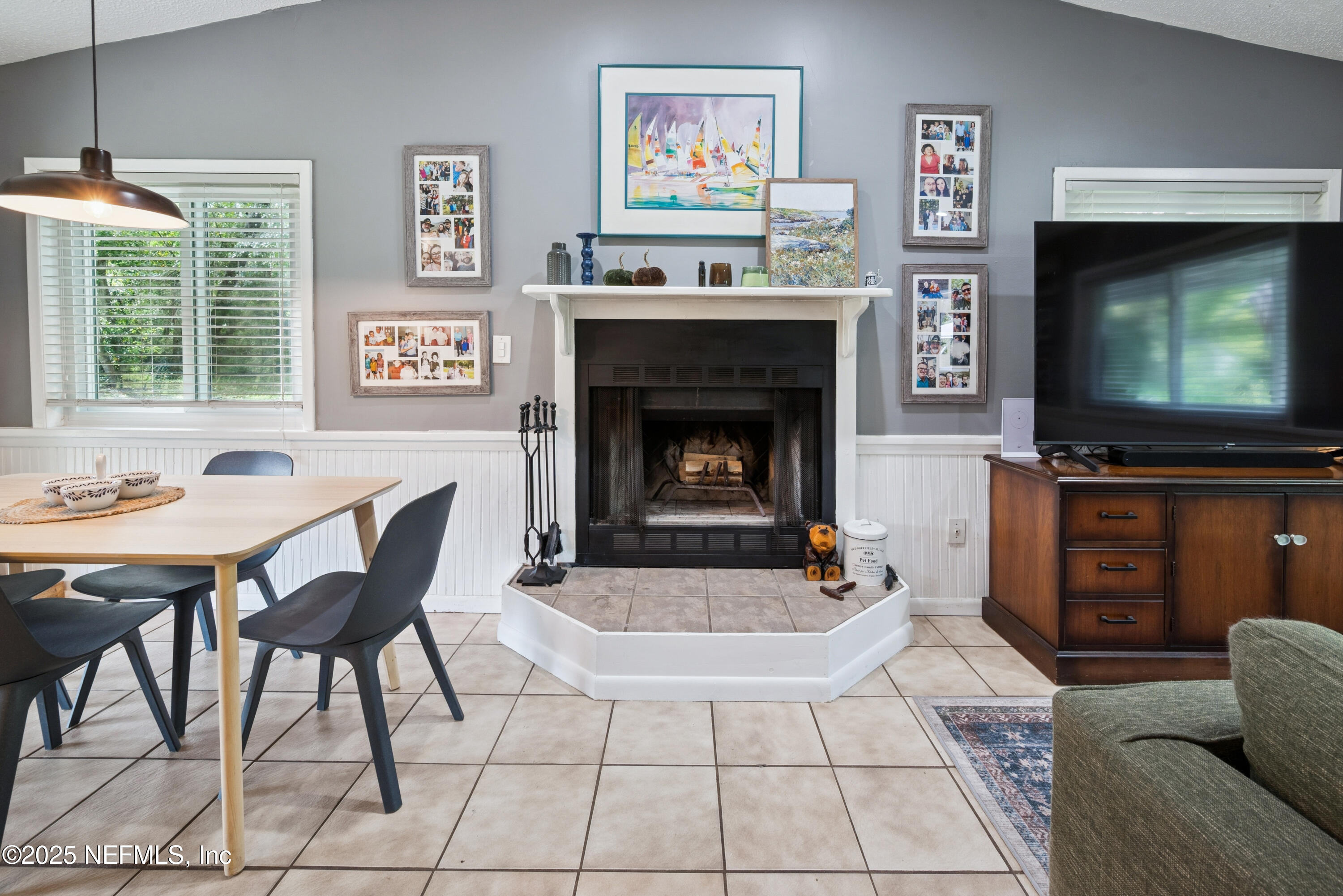18311 Northeast 21 Street Gainesville, FL 32609 - Photo 18 of 80 a living room with furniture a flat screen tv and a fireplace