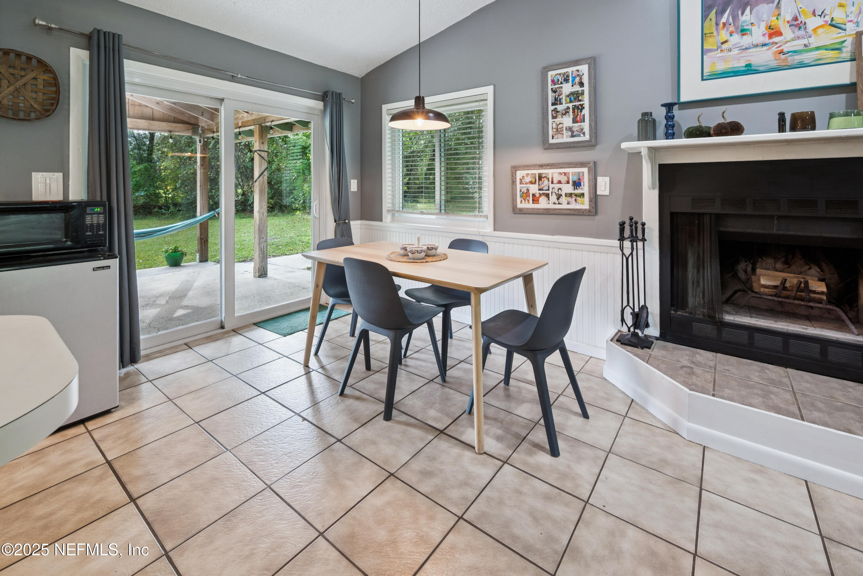 18311 Northeast 21 Street Gainesville, FL 32609 - Photo 19 of 80 a dining room with furniture and a fireplace