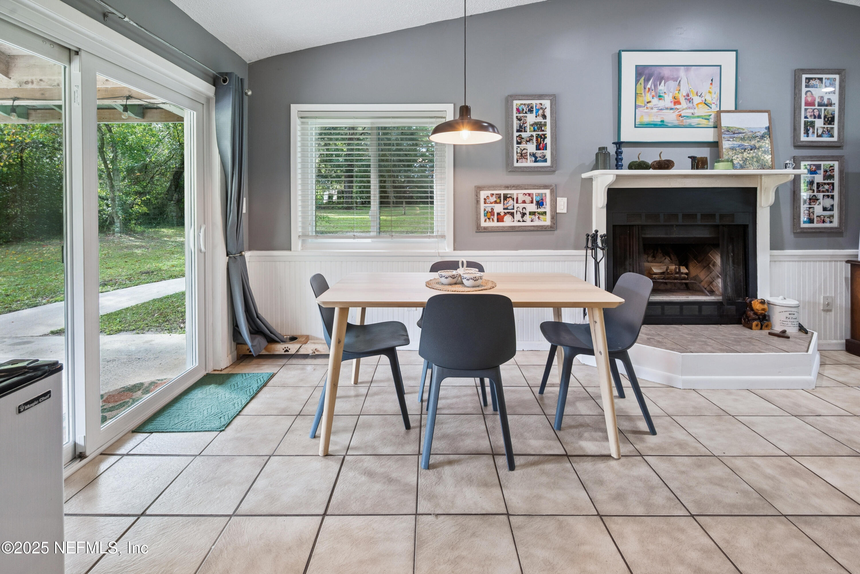 18311 Northeast 21 Street Gainesville, FL 32609 - Photo 20 of 80 a dining room with furniture and a fireplace