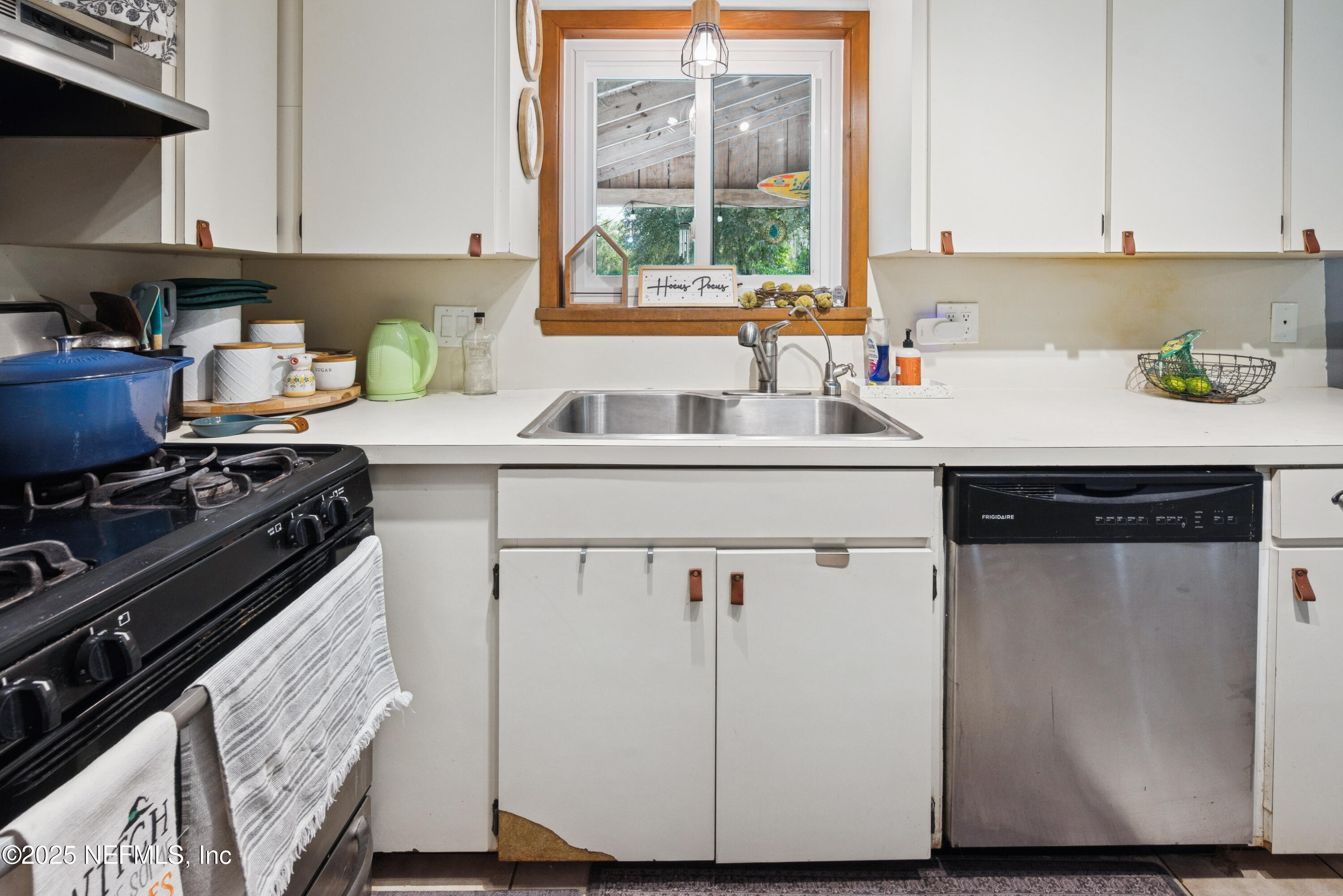 18311 Northeast 21 Street Gainesville, FL 32609 - Photo 26 of 80 a kitchen with a sink stove and cabinets