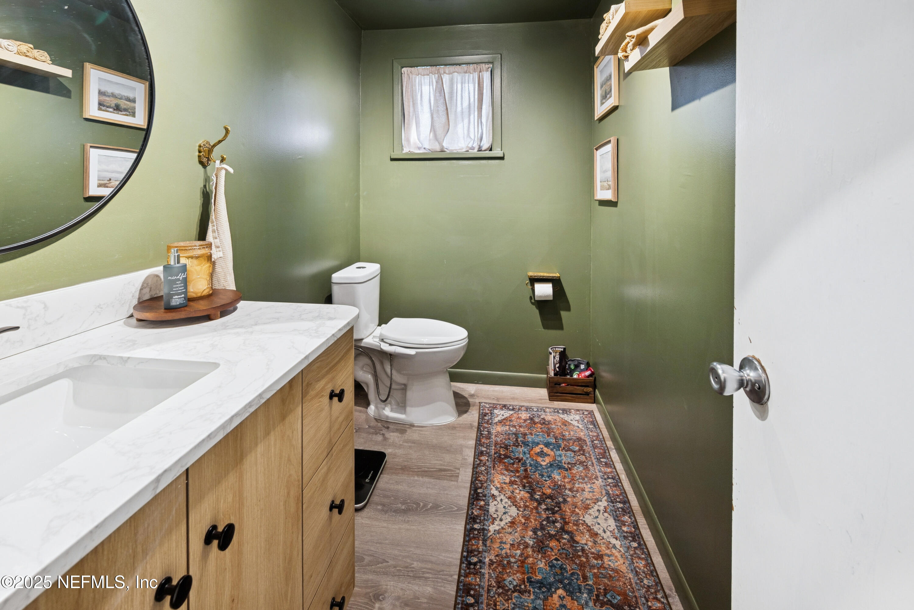 18311 Northeast 21 Street Gainesville, FL 32609 - Photo 28 of 80 a bathroom with a sink and a mirror