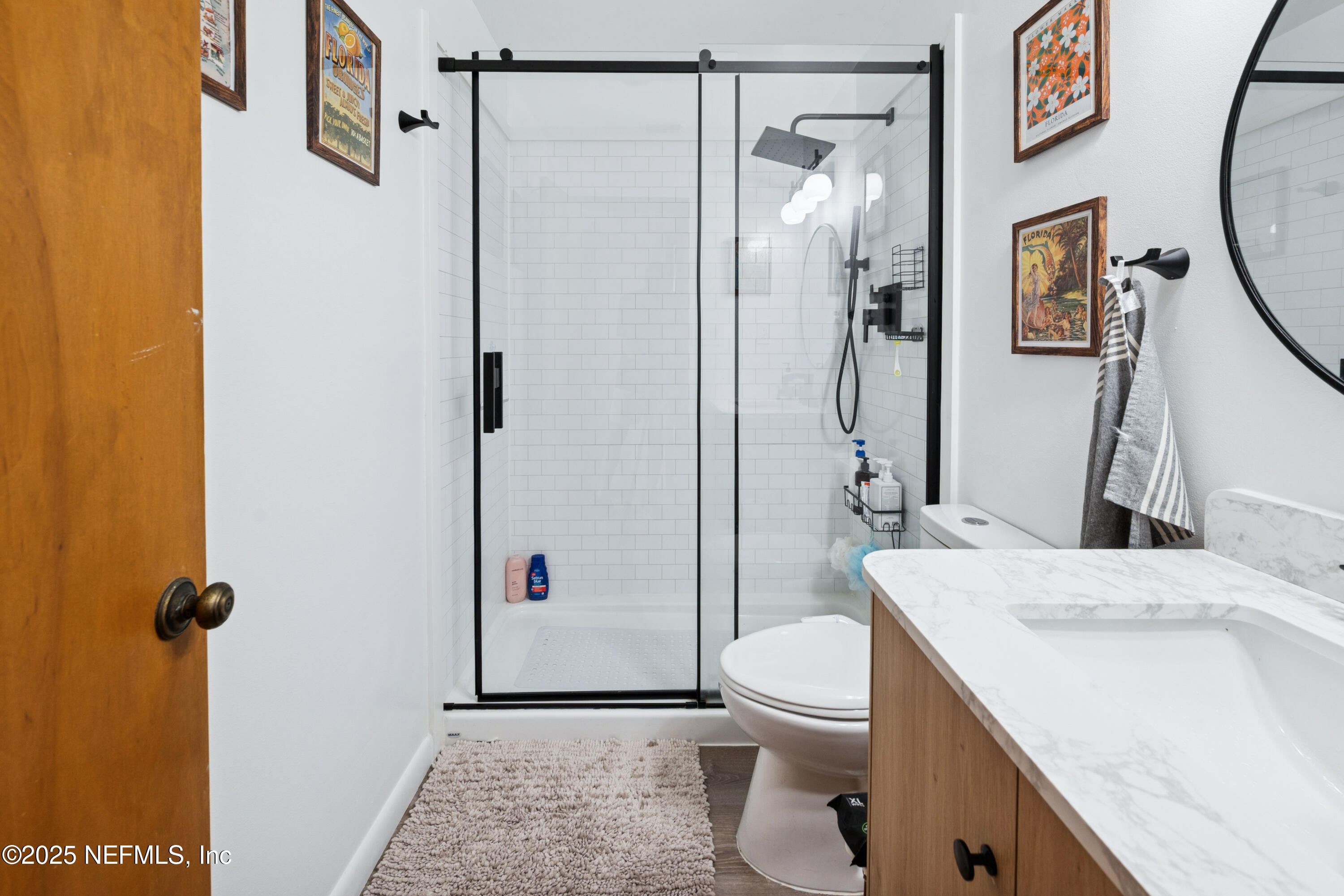 18311 Northeast 21 Street Gainesville, FL 32609 - Photo 37 of 80 a bathroom with a sink a toilet and shower
