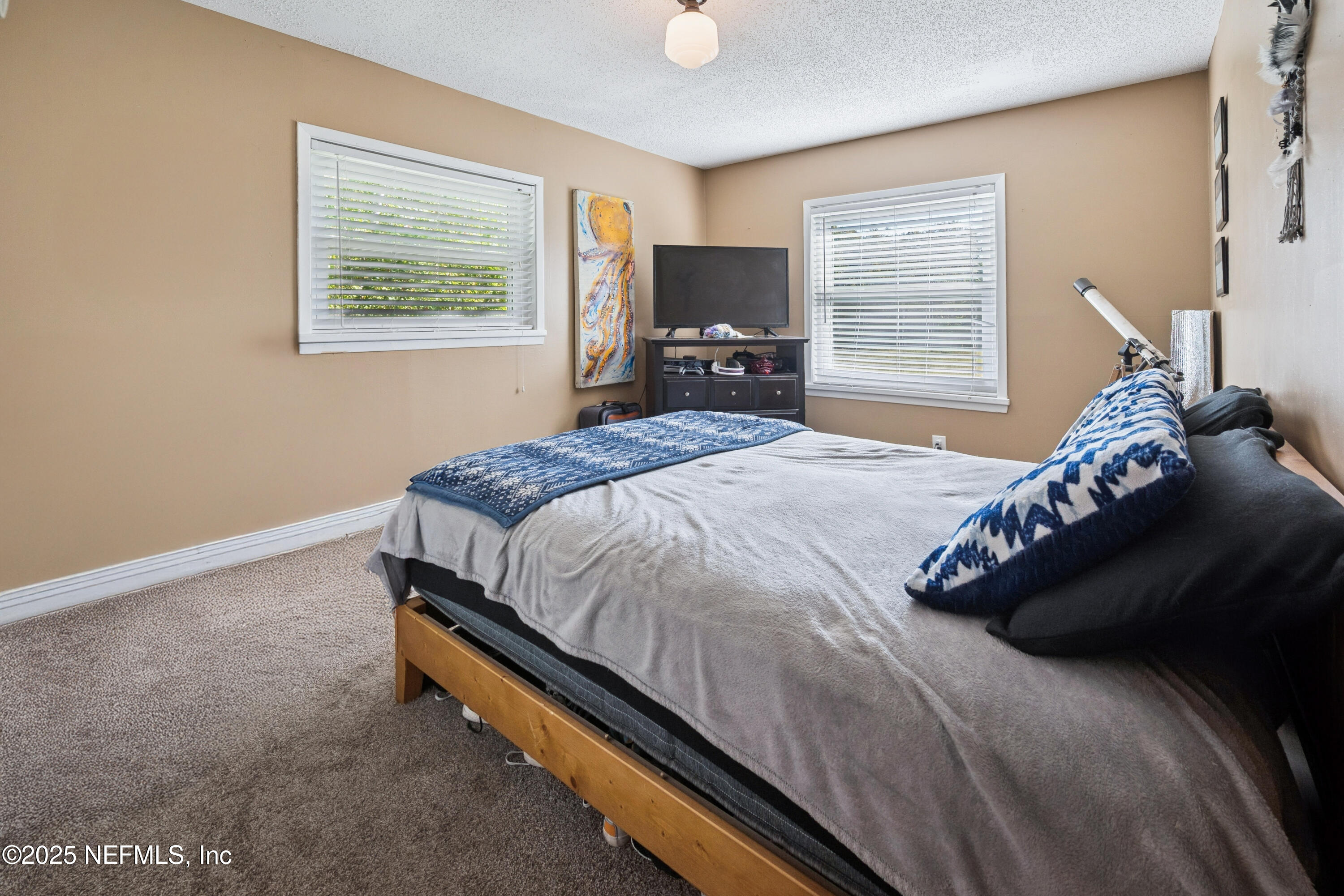 18311 Northeast 21 Street Gainesville, FL 32609 - Photo 39 of 80 a bedroom with a bed and wooden floor