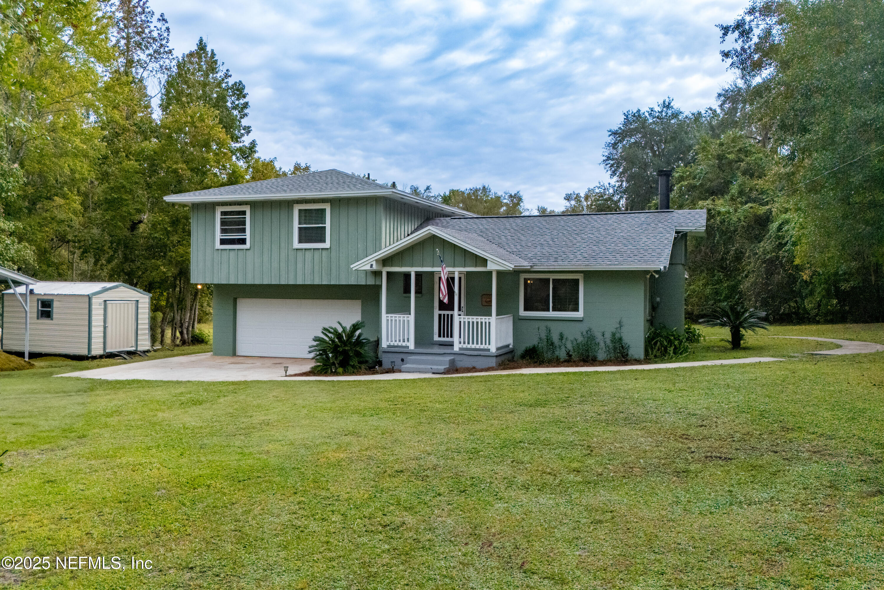 18311 Northeast 21 Street Gainesville, FL 32609 - Photo 4 of 80 a front view of a house with a garden