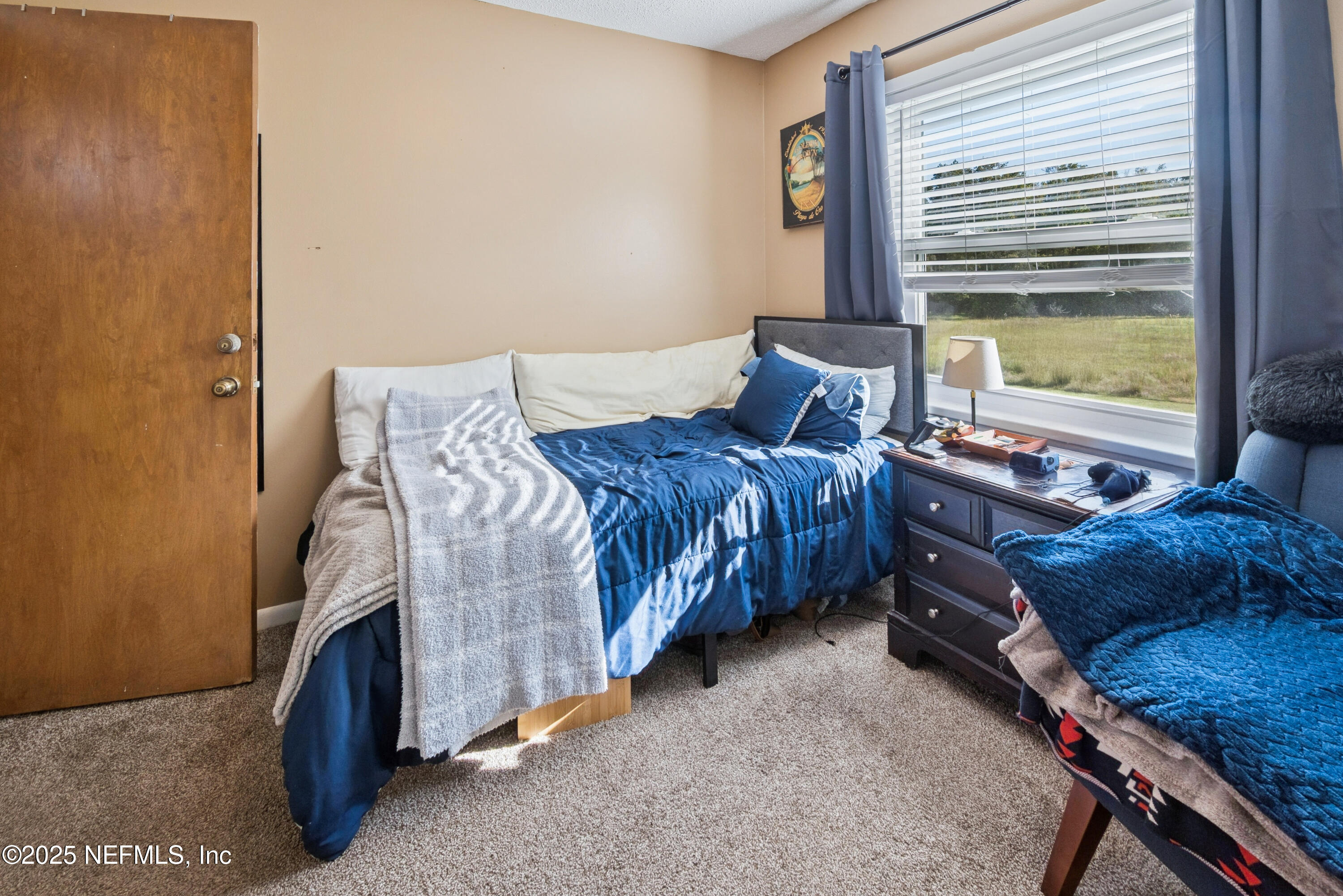 18311 Northeast 21 Street Gainesville, FL 32609 - Photo 43 of 80 a bedroom with a bed and a window