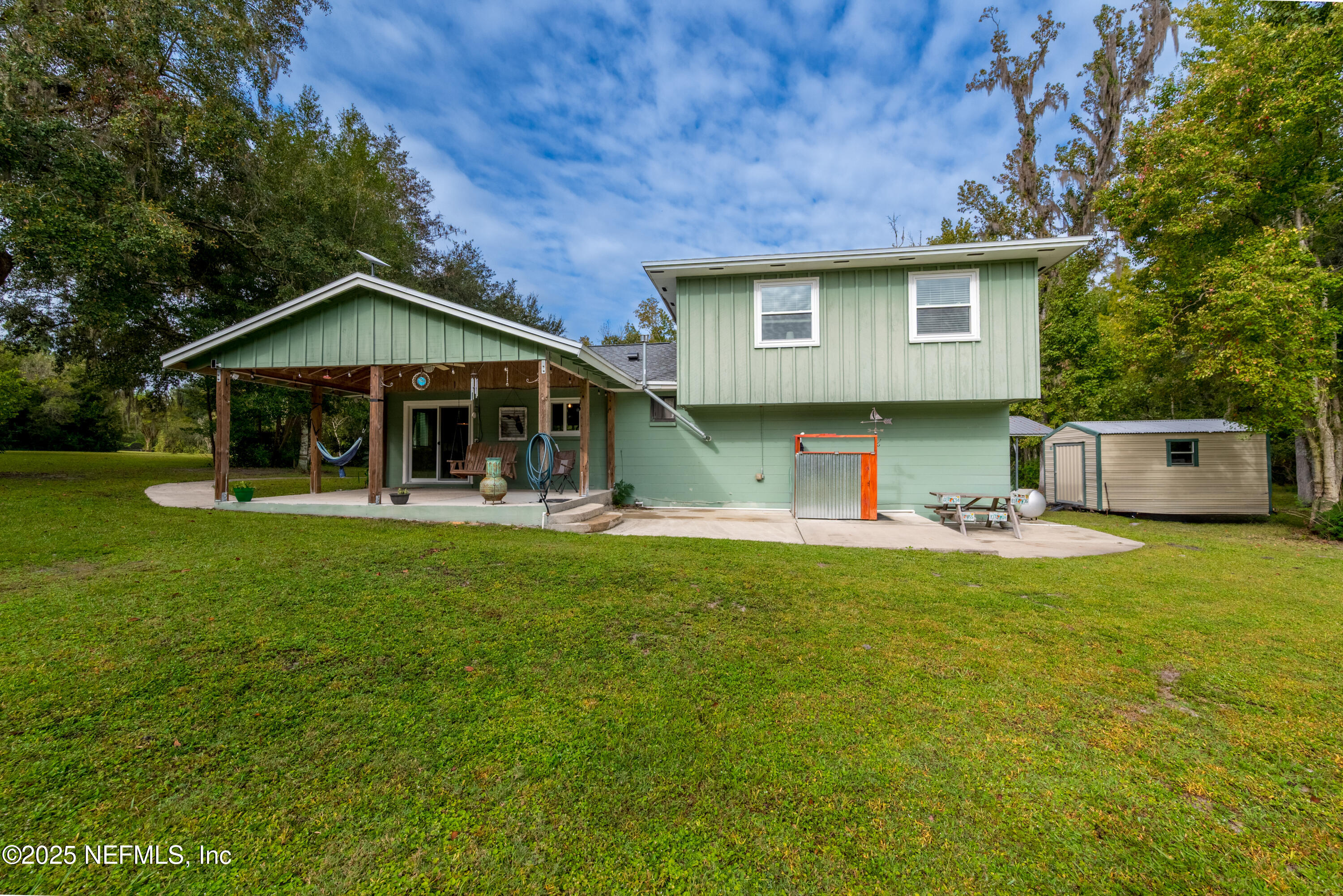 18311 Northeast 21 Street Gainesville, FL 32609 - Photo 49 of 80 a view of a house with a yard patio and swimming pool