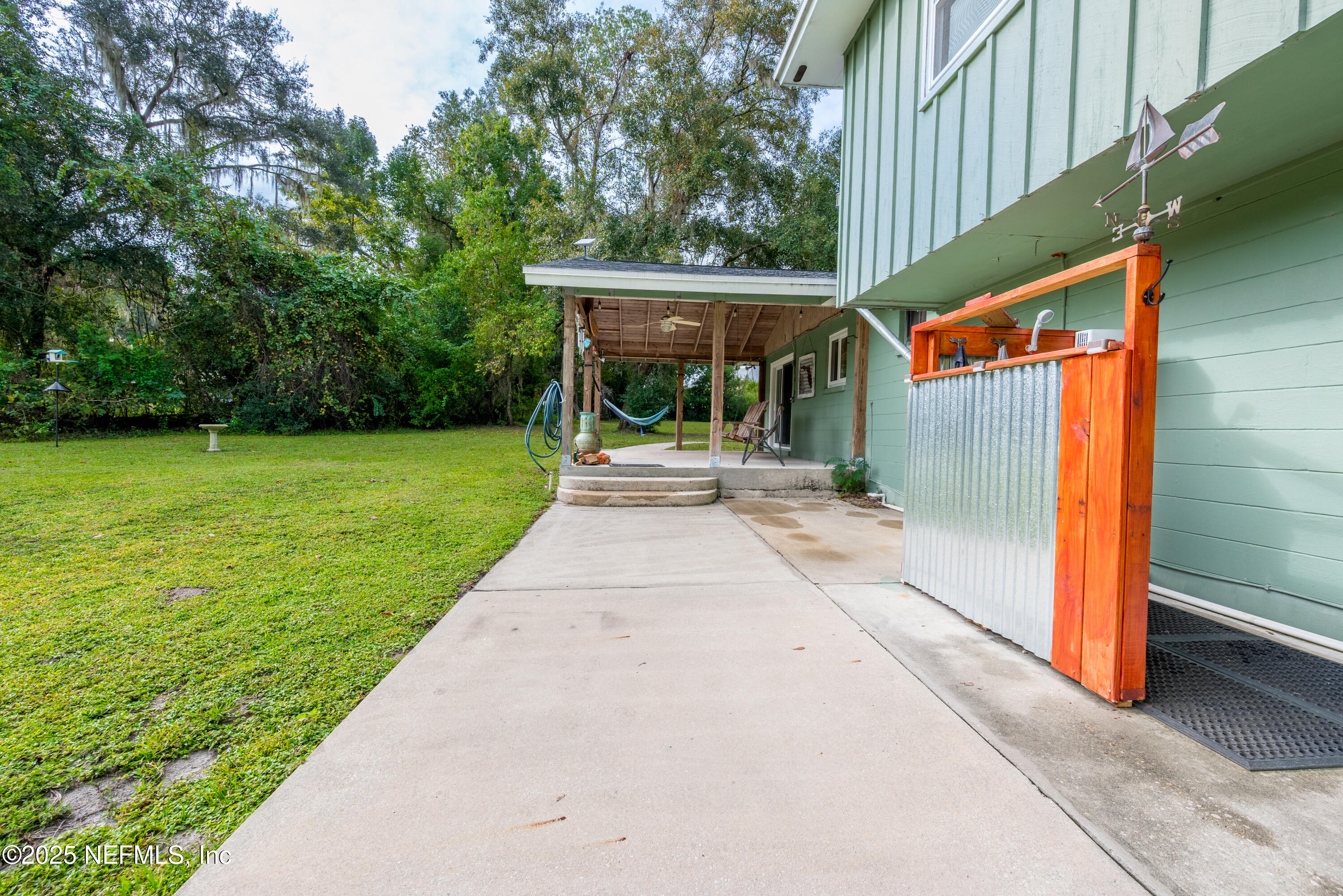 18311 Northeast 21 Street Gainesville, FL 32609 - Photo 51 of 80 a view of a house with backyard and a patio