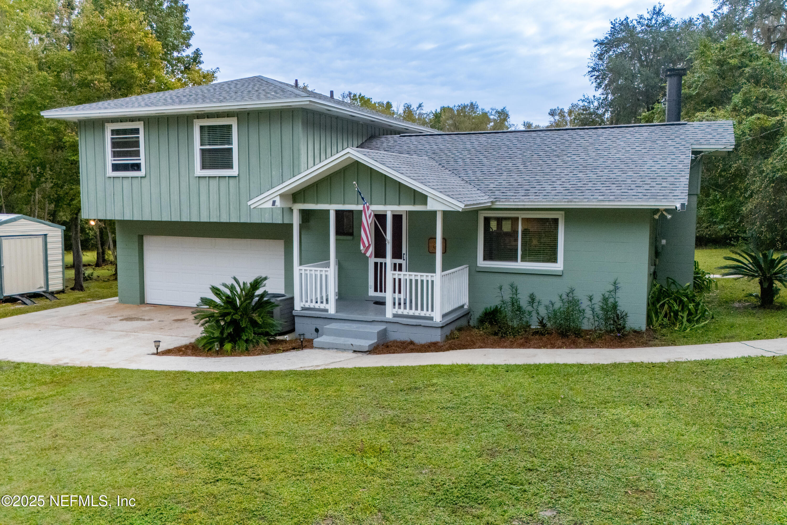 18311 Northeast 21 Street Gainesville, FL 32609 - Photo 8 of 80 a front view of a house with a yard and garage