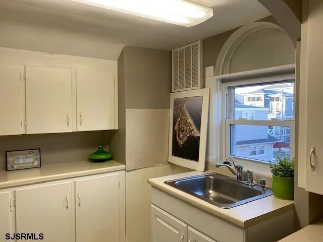 a kitchen with a sink and cabinets