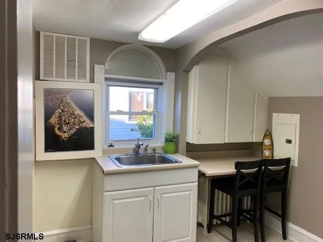 a kitchen with a sink cabinets and a window