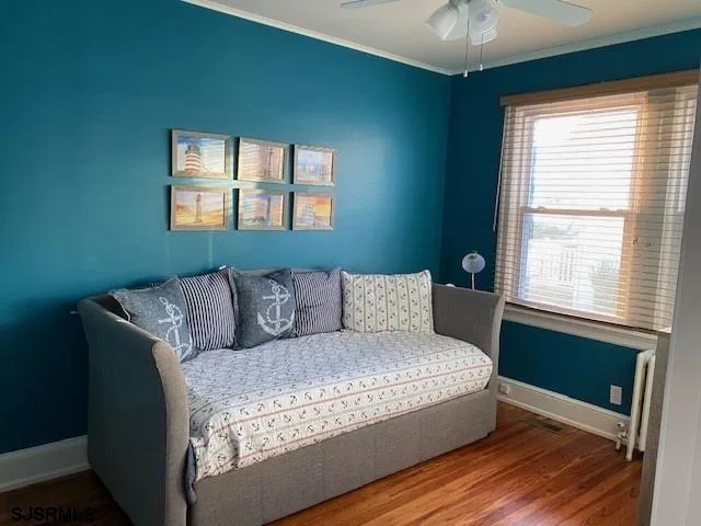 a large bed sitting in a bedroom next to a window