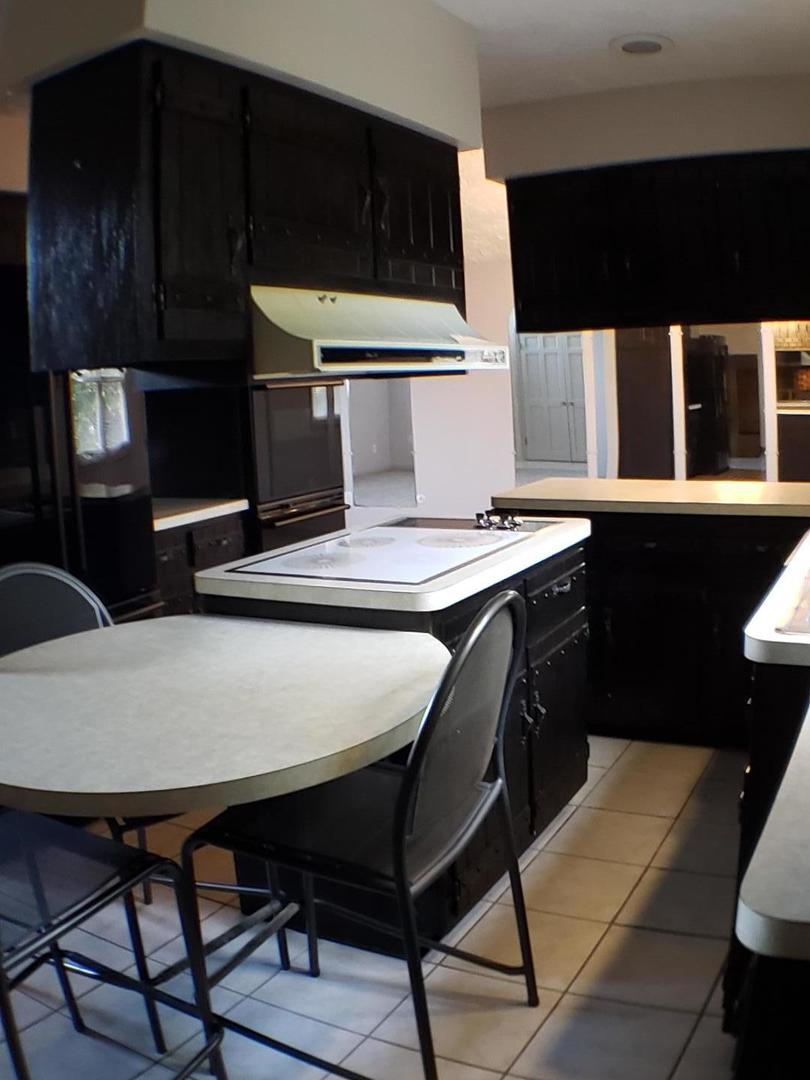 24805 Murphy Road Wilmington, IL 60481 - Photo 11 of 20 a kitchen with a table chairs and a refrigerator