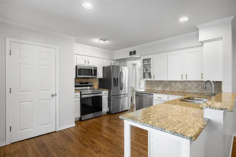 a kitchen with a sink stove and refrigerator