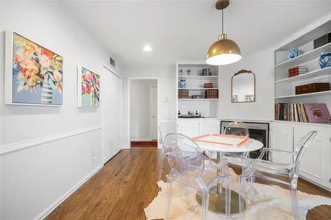 a view of a dining room with furniture window and wooden floor