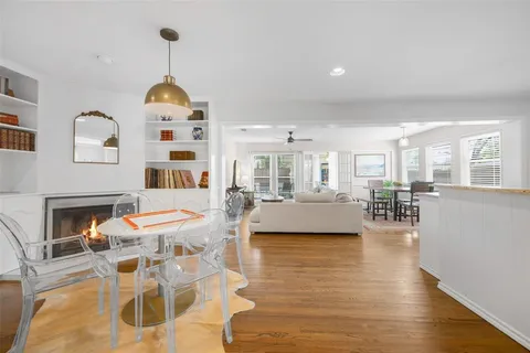 a view of a livingroom with furniture a fireplace and wooden floor