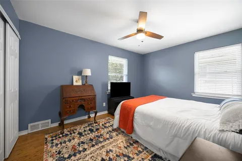 a bedroom with a bed and a table with closet