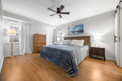 a bedroom with a bed dresser and a window