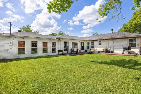 a view of a house with a backyard porch and sitting area