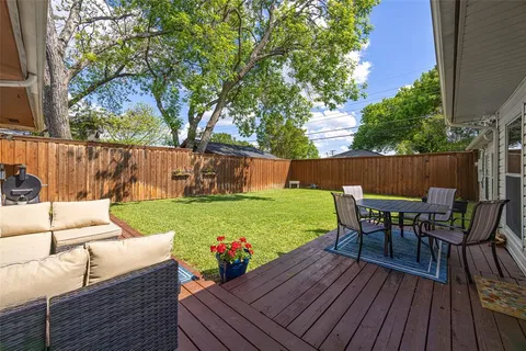 a view of a deck with furniture and a yard