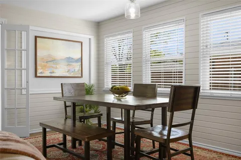 a view of a dining room with furniture and window