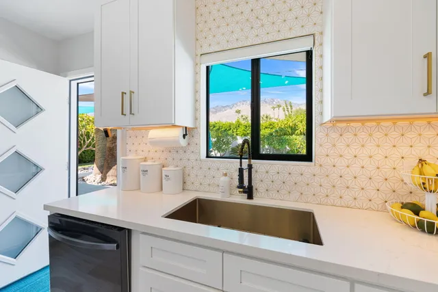 a kitchen that has a table chairs and a refrigerator