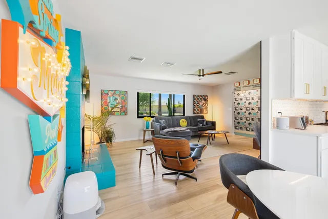 a living room with furniture and a mirror