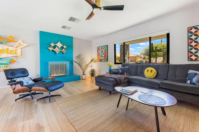 a living room with furniture a rug and a flat screen tv