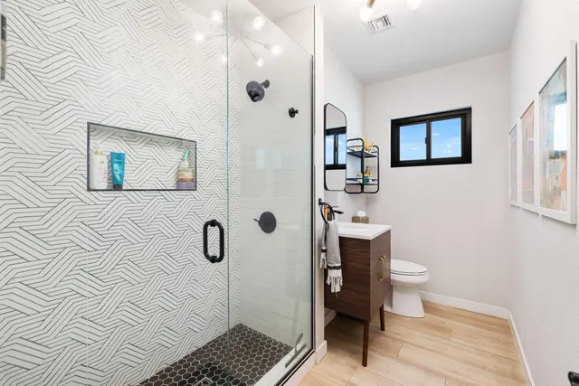 a bathroom with a toilet sink and mirror