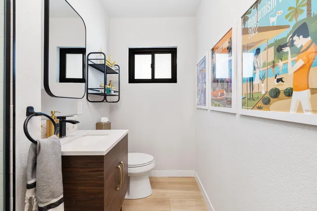 a bathroom with a toilet a sink and mirror