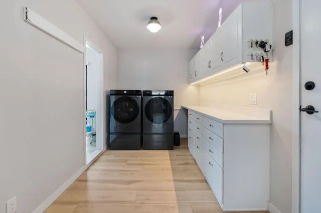 a room with a bed and a flat tv screen on dresser