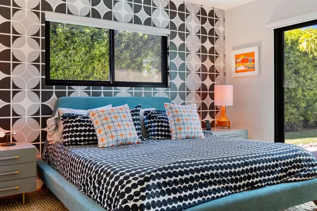 a bedroom with furniture and a potted plant