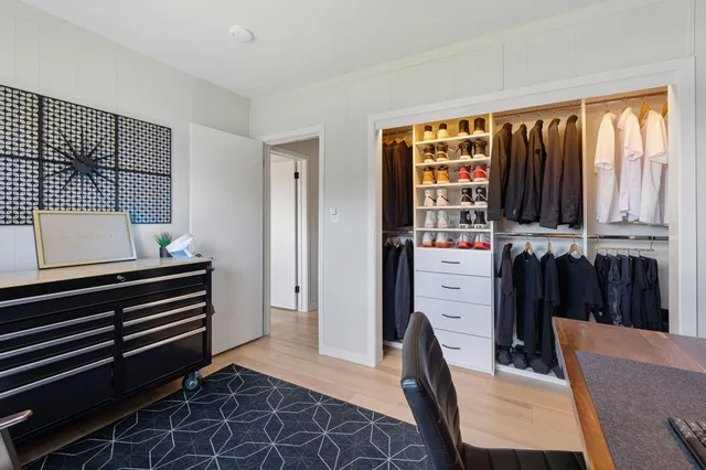 a bedroom with a bed dresser and a window