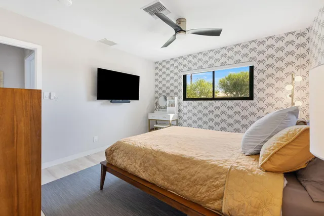 a view of a patio with a table and chairs under an umbrella