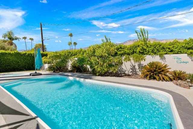 a view of a swimming pool with a yard