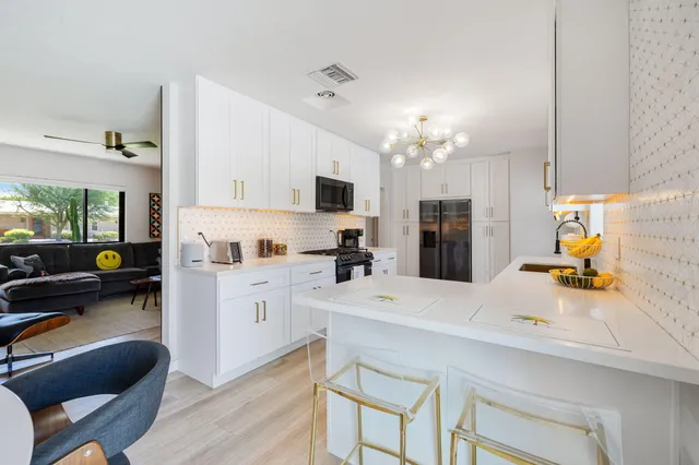 a kitchen with a refrigerator and countertop cabinets
