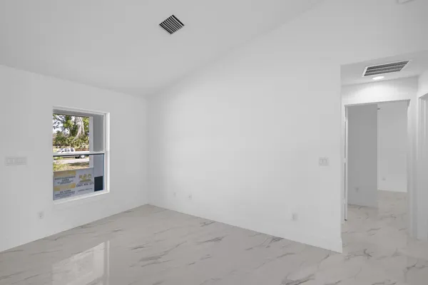 an empty room with windows and closet
