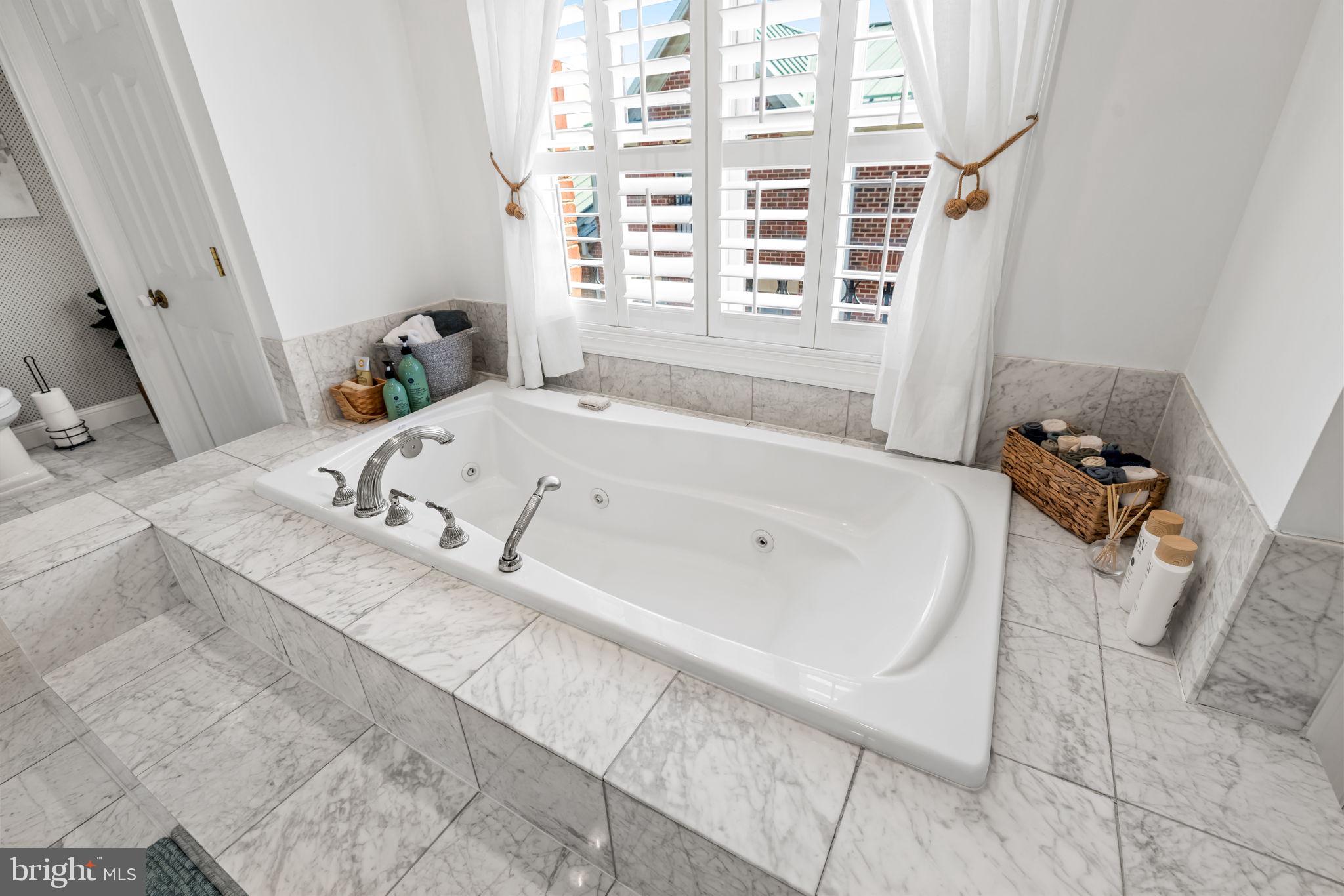 2331 Boston Street, Unit 1 Baltimore, MD 21224 - Photo 58 of 74 a bath tub sitting in a bathroom next to a window