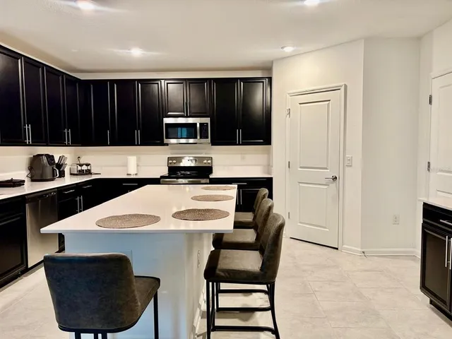 a kitchen with a sink and a refrigerator