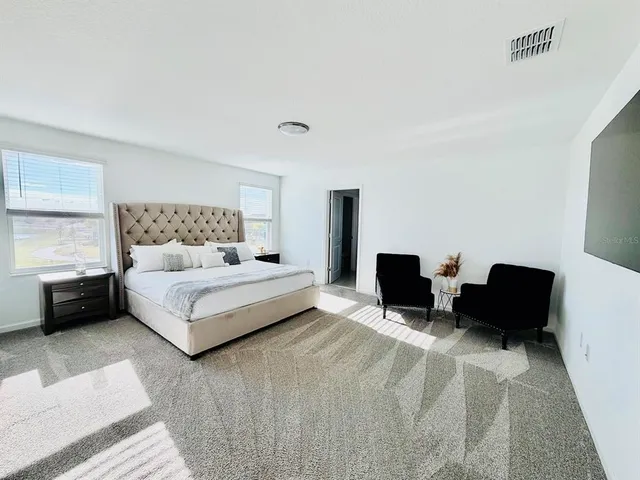 a bedroom with a bed and a couch