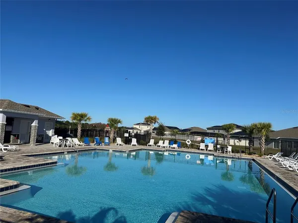 a view of swimming pool with outdoor seating