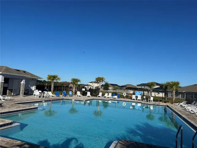 a view of swimming pool with outdoor seating