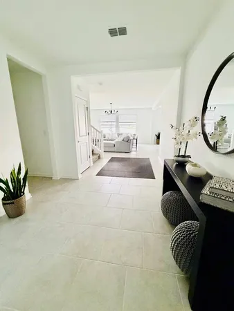 a living room with furniture and a potted plant