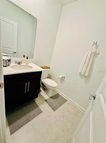 a bathroom with a sink mirror vanity and toilet