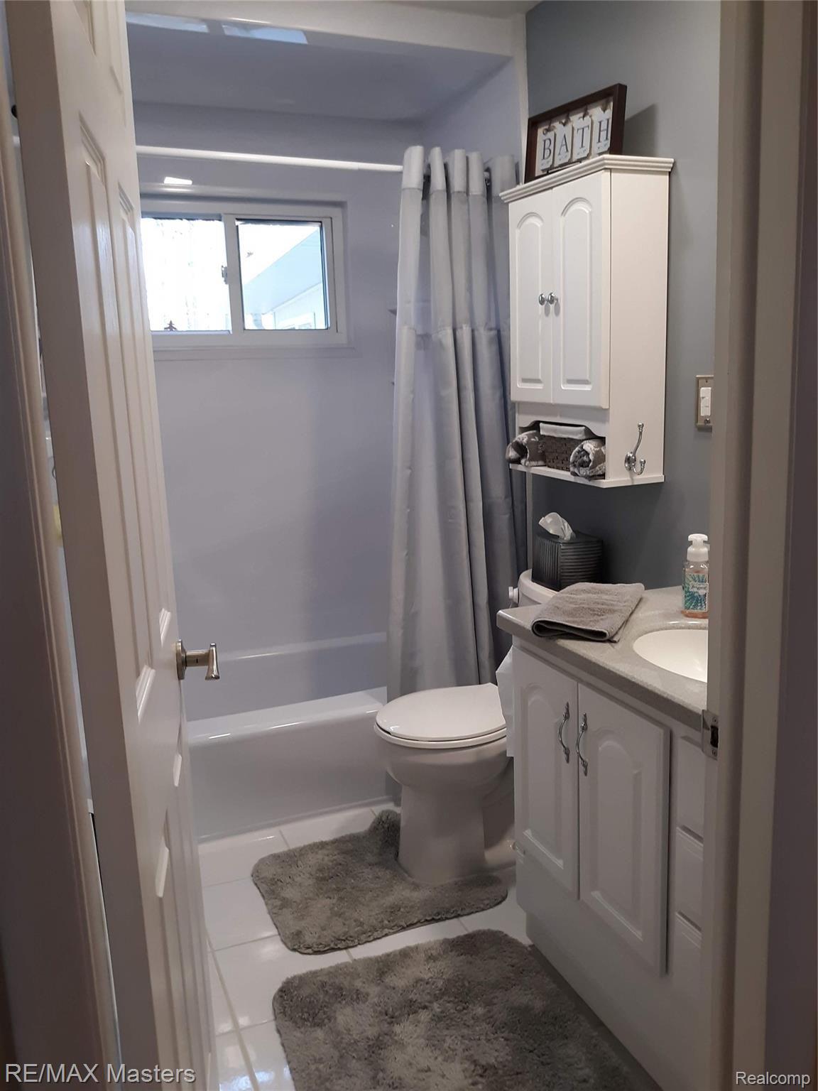 3268 Heiss Road Monroe, MI 48162 - Photo 13 of 20 Tiled bathroom with newer vanity, tub shower insert features life time warranty and is in great condition!