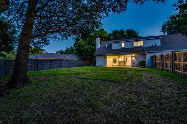 a view of an house with backyard space and garden