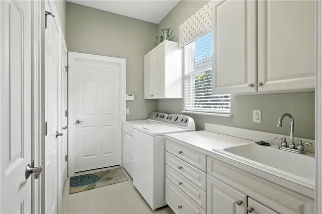 a view of a sink and washer dryer