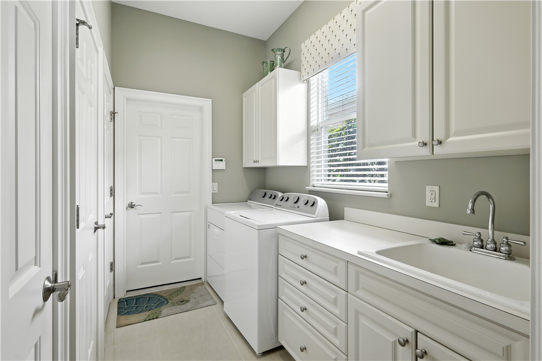 620 Bridgewater Lane Southwest Vero Beach, FL 32962 - Photo 11 of 31 a view of a sink and washer dryer