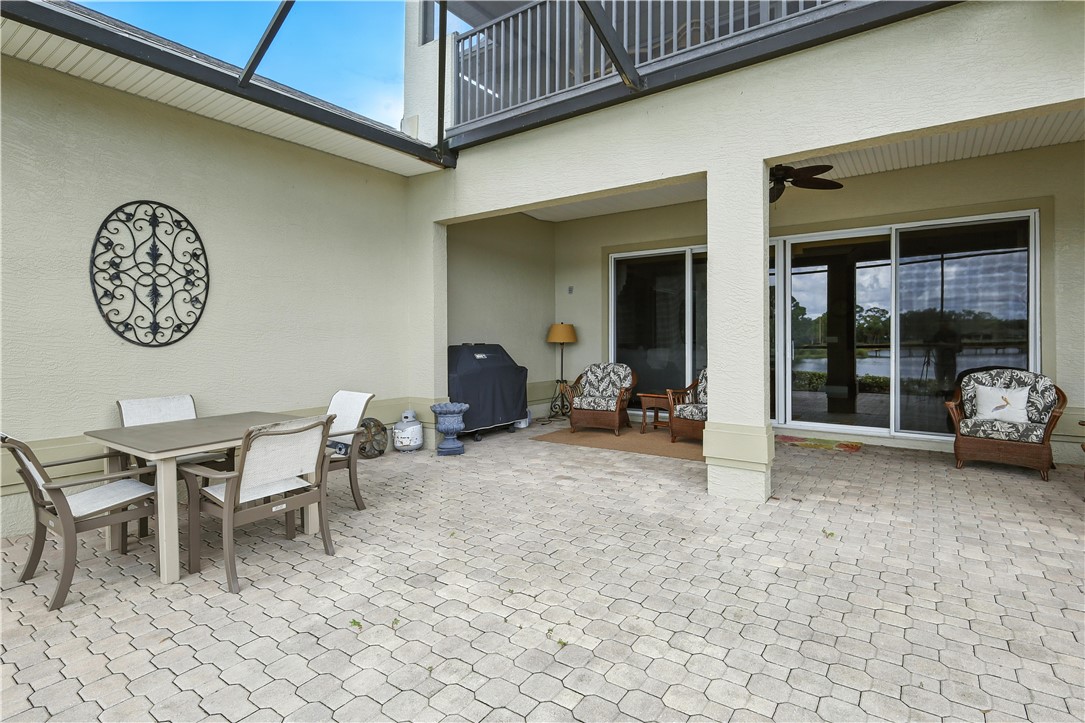620 Bridgewater Lane Southwest Vero Beach, FL 32962 - Photo 13 of 31 a view of a dinning table and chairs in back of a building