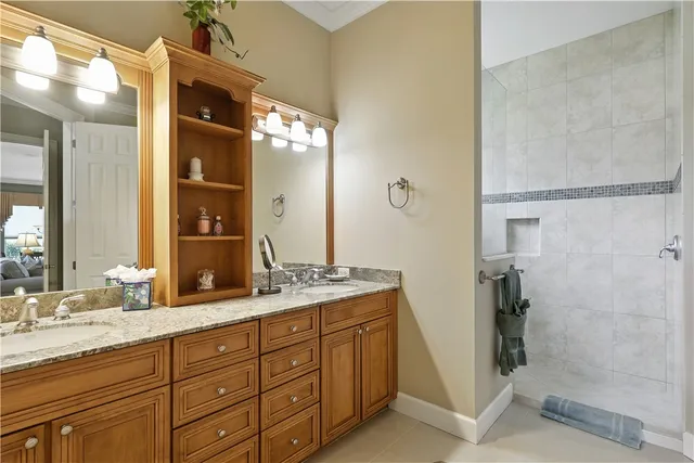 a bathroom with a granite countertop sink a mirror and a shower