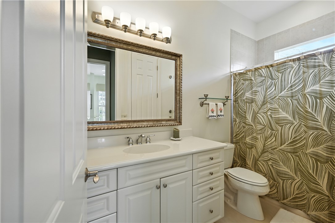 620 Bridgewater Lane Southwest Vero Beach, FL 32962 - Photo 17 of 31 a bathroom with a sink vanity mirror and toilet